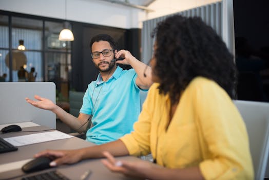 Professional team discussing and working together at a call center in a modern office setting.