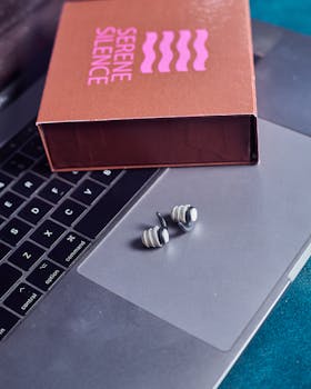 Serene Silence earplugs on a laptop, reflecting modern technology and lifestyle.