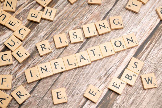 Wooden letter tiles spell 'rising inflation' symbolizing economic concerns.